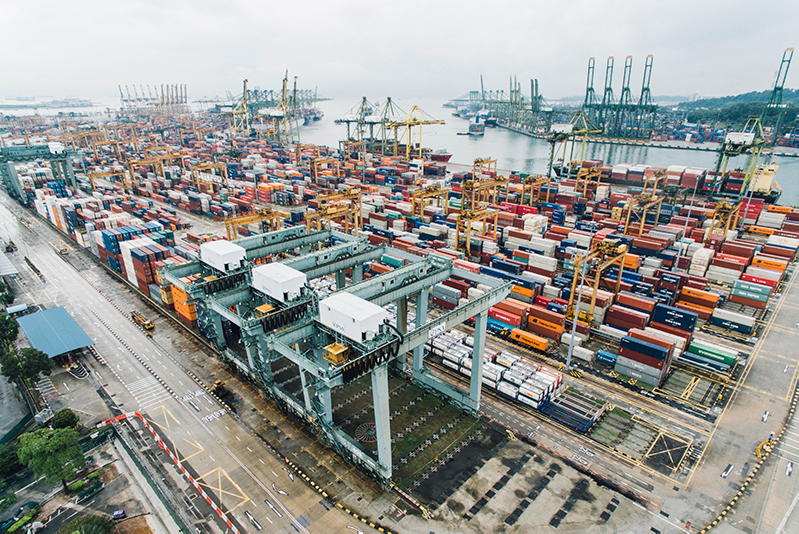 Shipping containers on a dock with cranes