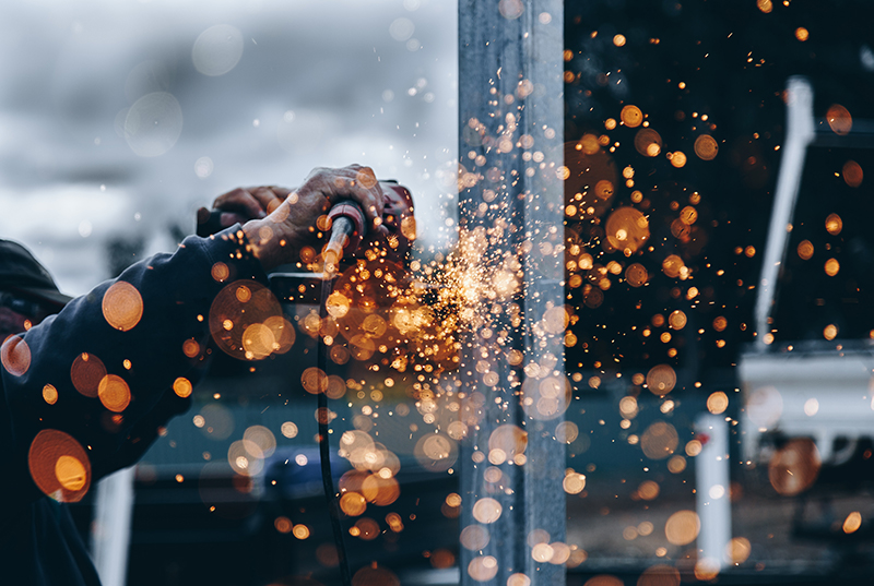 A grinder cutting metal and spraying sparks